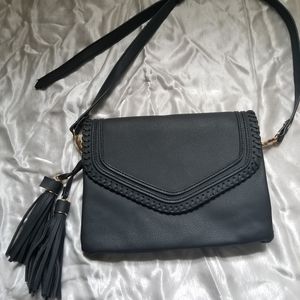 Small black purse with short shoulder strap.
